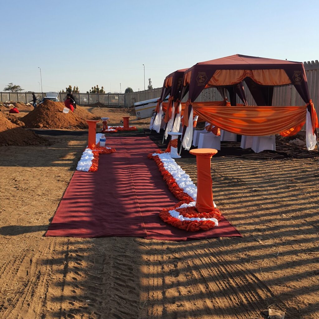 Ithemba Elitjha gravesite deco which consists of red carpet, covered chairs and a decorated gazebo at a cemetery in KwaMhlanga, Mpumalanga